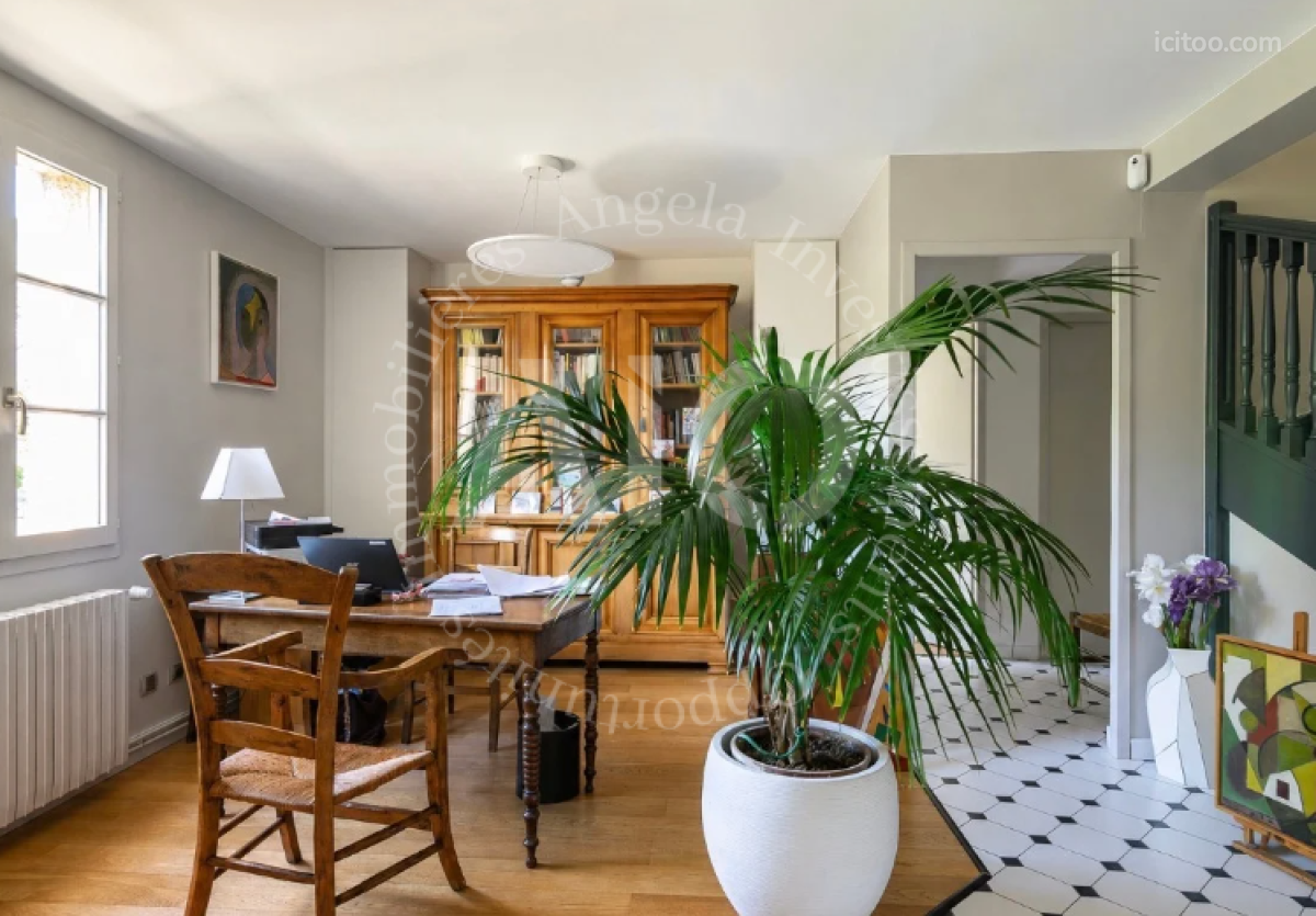Bureau aménagé avec meuble en bois, chaise et grande plante verte, villa à vendre à Couzon-au-Mont-d'Or.